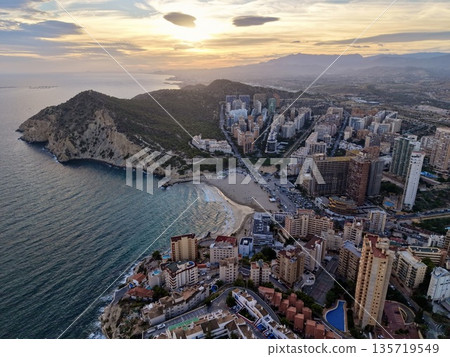 breathtaking aerial scene showcasing opulent skyscrapers near tranquil sea and dramatic cloud formations breathtaking aerial scene showcasing opulent skyscrapers near tranquil sea and dramatic cloud formations 135719549