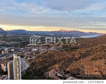 urban coastline with skyscrapers view, seaside urban panorama showing highrise buildings and mountains urban coastline with skyscrapers view, seaside urban panorama showing highrise buildings and mountains 135719629