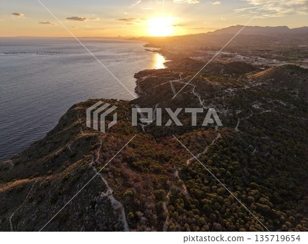 sea cliffs panorama, dramatic coastline with sunset, vivid ocean scene with silhouettes and reflections sea cliffs panorama, dramatic coastline with sunset, vivid ocean scene with silhouettes and reflections 135719654