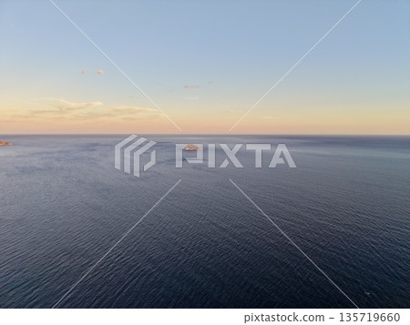 quiet isle at dawn surrounded, untouched island during sunrise amidst tranquil sea surroundings quiet isle at dawn surrounded, untouched island during sunrise amidst tranquil sea surroundings 135719660