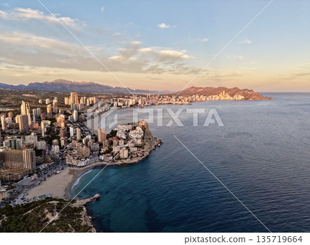 serene evening at seaside city, calm twilight casting gentle glow on maritime cityscape and shores serene evening at seaside city, calm twilight casting gentle glow on maritime cityscape and shores 135719664