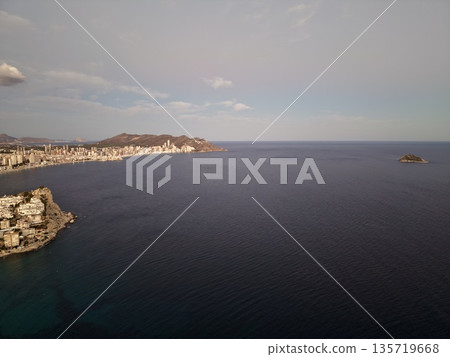 serene seaside scene, peaceful shoreline with muted tones and elongated shadows create reflection serene seaside scene, peaceful shoreline with muted tones and elongated shadows create reflection 135719668
