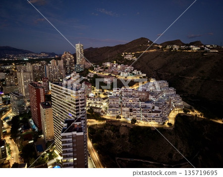 city night scene, nighttime cityscape showcasing illuminated skyscrapers and winding hillside roads city night scene, nighttime cityscape showcasing illuminated skyscrapers and winding hillside roads 135719695