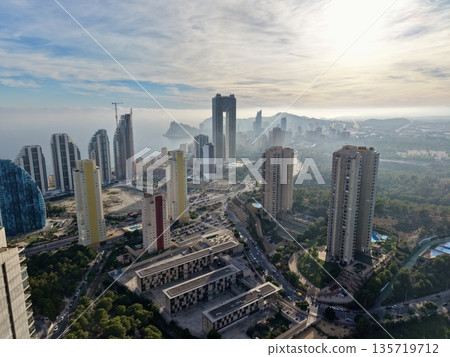 sunrise cityscape spectacle, dawn breaks over bustling urban area with highlights and haze 135719712