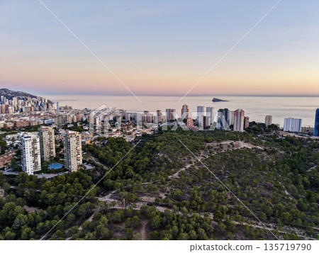 coastline mountain vista, panoramic aerial image showcasing natural landscape and city silhouette at dawn coastline mountain vista, panoramic aerial image showcasing natural landscape and city silhouette at dawn 135719790