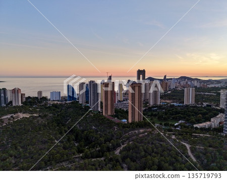 luxurious seaside skyline scene, sunset glow over elegant seaside resort with towering structures luxurious seaside skyline scene, sunset glow over elegant seaside resort with towering structures 135719793