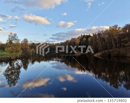 water mirrors sky, capturing broad perspective of bright sky reflected on tranquil lake surface water mirrors sky, capturing broad perspective of bright sky reflected on tranquil lake surface 135719802