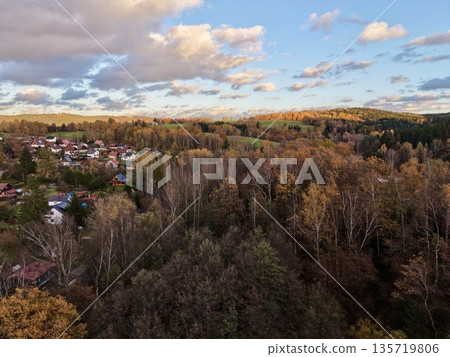 village near forest with greenery, remote settlement by trees featuring colorful seasonal scenery 135719806