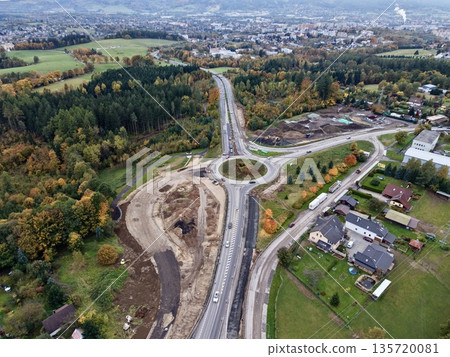 suburban roundabout being built, engineer inspecting site amidst seasonal autumn scenery and clouds suburban roundabout being built, engineer inspecting site amidst seasonal autumn scenery and clouds 135720081