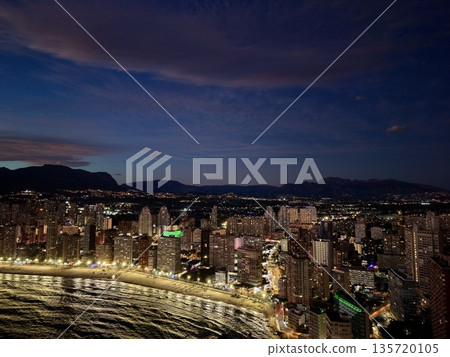 coastal twilight enhances visual splendor, sunset illuminates shore with shimmering water surfaces 135720105