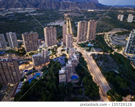 sunny cityscape views, morning sunlight bathes skyscrapers and expansive avenues overlooking ocean 135720128