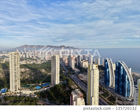 modern towers over tranquil bay, contemporary glass structures near peaceful water and sprawling city modern towers over tranquil bay, contemporary glass structures near peaceful water and sprawling city 135720132