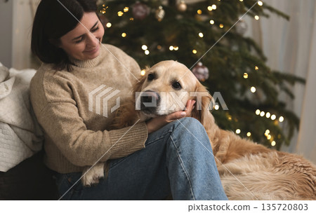 Female Owner At Home Petting Adorable Golden Retriever Dog Female Owner At Home Petting Adorable Golden Retriever Dog 135720803