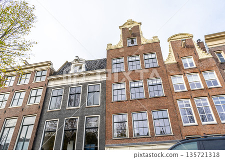 Canal Houses facade of Amsterdam City in Netherlands street building architecture. 135721318