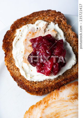 Open sandwich from leftover turkey and cranberry sauce 135721417
