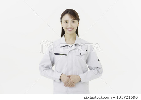 Young Japanese woman in work clothes on white background Young Japanese woman in work clothes on white background 135721596