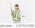 A young Japanese woman wearing work clothes with a safety belt and holding an emergency exit sign on a white background 135721599