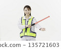 A young Japanese woman wearing work clothes with a safety belt and holding an emergency exit sign on a white background 135721603