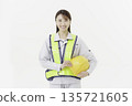 A young Japanese woman wearing a safety belt and helmet in work clothes against a white background 135721605