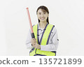 A young Japanese woman wearing work clothes with a safety belt and holding an emergency exit sign on a white background 135721899