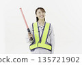 A young Japanese woman wearing work clothes with a safety belt and holding an emergency exit sign on a white background 135721902