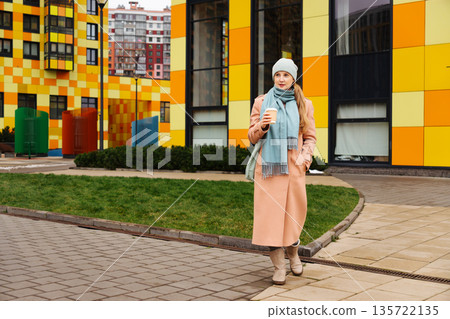 A woman walks through the courtyard of her house 135722135