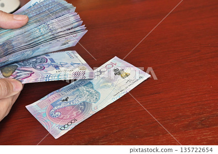 Tenge. Paper Kazakh money and calculator on the table close-up. 135722654