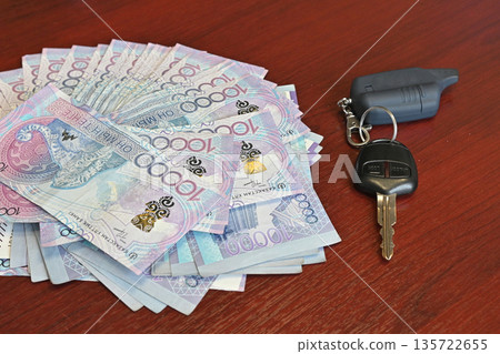 Tenge. Paper Kazakh money and calculator on the table close-up. Tenge. Paper Kazakh money and calculator on the table close-up. 135722655