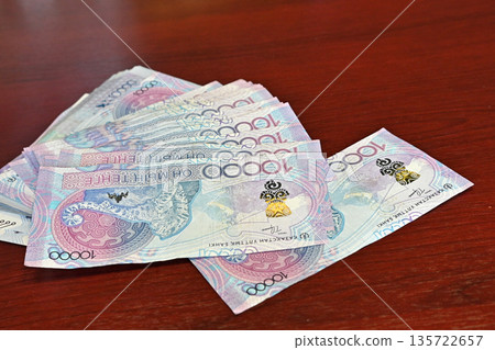Tenge. Paper Kazakh money and calculator on the table close-up. Tenge. Paper Kazakh money and calculator on the table close-up. 135722657