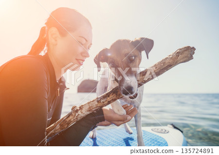 Woman Dog Stick Paddleboarding Beach Woman Dog Stick Paddleboarding Beach 135724891