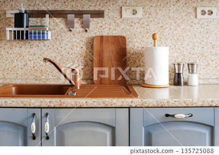 Clean kitchen sink and countertop with wooden board and accessories 135725088