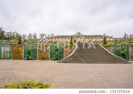 Sanssouci Palace Gardens with Grand Staircase in Potsdam, Germany. Old building architecture in Rococo style garden 135725610