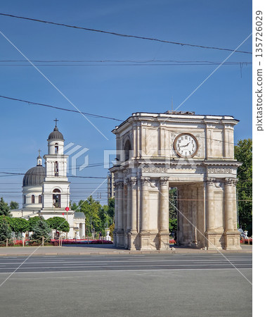 Chisinau, Moldova - September 24, 2025 Triumphal Arch as popular historical landmark of the capital with the Metropolitan Cathedral Nativity of the Lord and the bell tower in the background 135726029