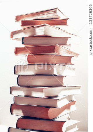 Stack of books in library. Scientific, educational, and fiction paper books. Education and training. Stack of books in library. Scientific, educational, and fiction paper books. Education and training. 135726366