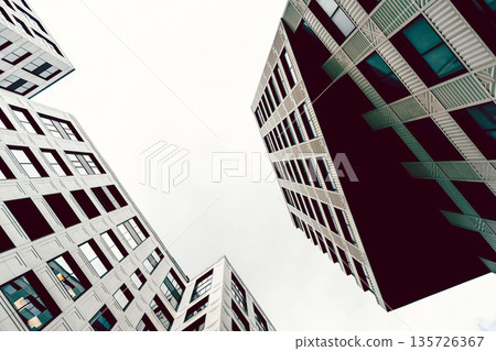 High-rise buildings of modern city. View from below. High-rise buildings of modern city. View from below. 135726367