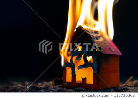 Mock up paper house is burning. Fire of an apartment building. Accident insurance. Mock up paper house is burning. Fire of an apartment building. Accident insurance. 135726368