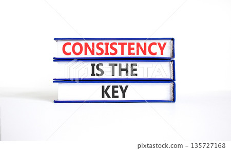 Consistency is the key symbol. Concept words Consistency is the key on beautiful books. Beautiful white paper background. Business consistency is the key concept. Copy space. 135727168
