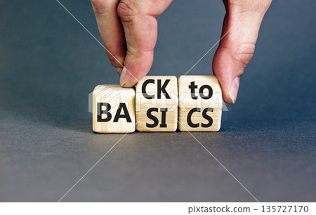 Back to basics symbol. Concept words Back to basics on wooden block. Beautiful grey table grey background. Businessman hand. Business back to basics concept. Copy space. Back to basics symbol. Concept words Back to basics on wooden block. Beautiful grey table grey background. Businessman hand. Business back to basics concept. Copy space. 135727170