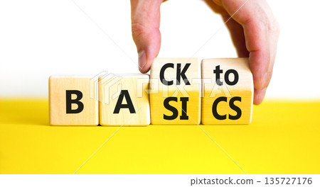Back to basics symbol. Concept words Back to basics on wooden block. Beautiful yellow table white background. Businessman hand. Business back to basics concept. Copy space. Back to basics symbol. Concept words Back to basics on wooden block. Beautiful yellow table white background. Businessman hand. Business back to basics concept. Copy space. 135727176