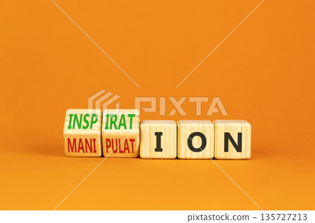 Inspiration or manipulation symbol. Concept words Inspiration and Manipulation on wooden cubes. Beautiful orange background. Psychology inspiration manipulation concept. Copy space. 135727213