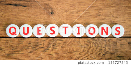 Question questions symbol. Concept word Questions on beautiful white circles. Beautiful wooden background. Business education support questions concept. Copy space. 135727243