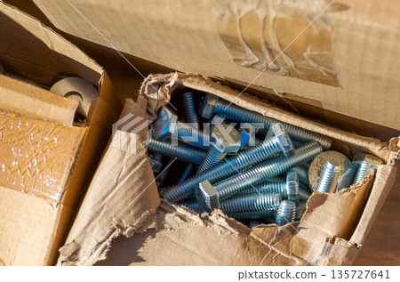 Cardboard Boxes with Open Box Containing Metal Screws 135727641