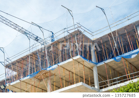 Urban Building Construction with Scaffolding and Crane 135727685