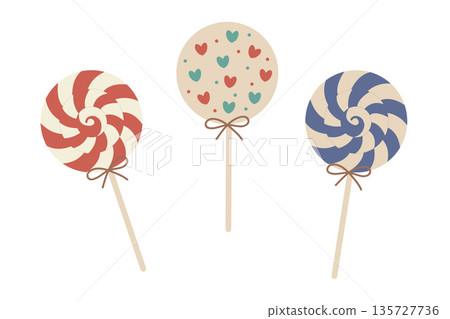 A set of three cute vector holiday lollipops in a swirl design. Features red, blue, and a heart-patterned sweet in soft 135727736