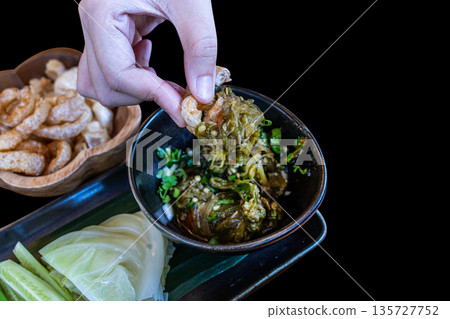 Top view of Nam prik num (Northern Thai Green Chilli Dip) and Pork snack thai food style focus selective Top view of Nam prik num (Northern Thai Green Chilli Dip) and Pork snack thai food style focus selective 135727752
