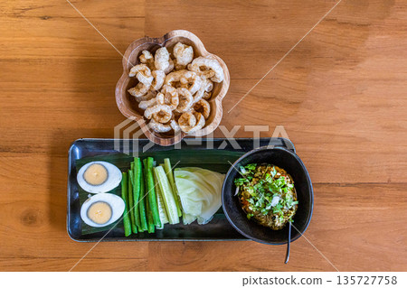 Top view of Nam prik num (Northern Thai Green Chilli Dip) and Pork snack thai food style focus selective Top view of Nam prik num (Northern Thai Green Chilli Dip) and Pork snack thai food style focus selective 135727758