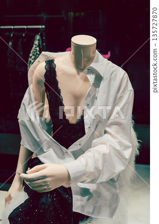 Female mannequin in black underwear. Storefront of women's clothing. 135727870