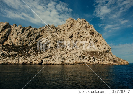 Rocky island cliff rising from Rocky island cliff rising from 135728267
