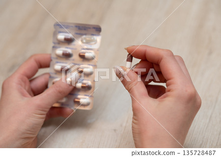 Woman's hand holding medicine Woman's hand holding medicine 135728487