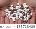 Woman's hand holding a lot of medicine 135728489